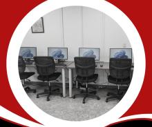 red background with picture of computers and chairs with white circle around picture